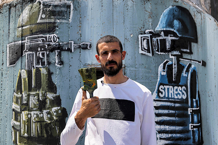 Palestinian artist Taqi Spateen paints breathtaking murals on Israeli  barrier | The nation press