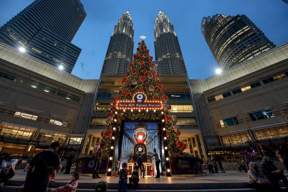 19 نوفمبر 2021، ماليزيا،كوالالمبور: الناس يتجمعون أمام شجرة عيد الميلاد في حديقة KLCC المطلة على برجي بتروناس التوأمين.(د ب أ)