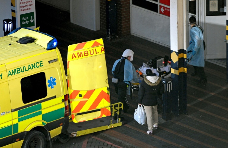 المسعفون تفريغ المريض من سيارة إسعاف لحالة كورنا (ا ف ب)