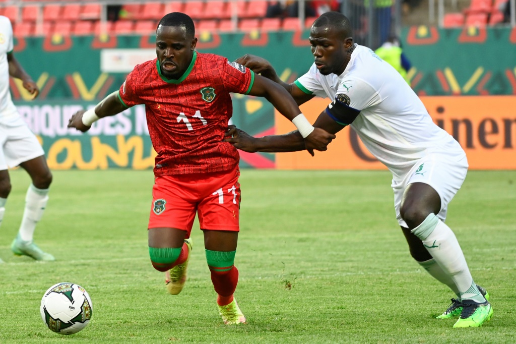 مدافع السنغال كاليدو كوليبالي (يمين) في صراع على الكرة مع مدافع مالاوي غابادينو مانغو (يسار) (ا ف ب)