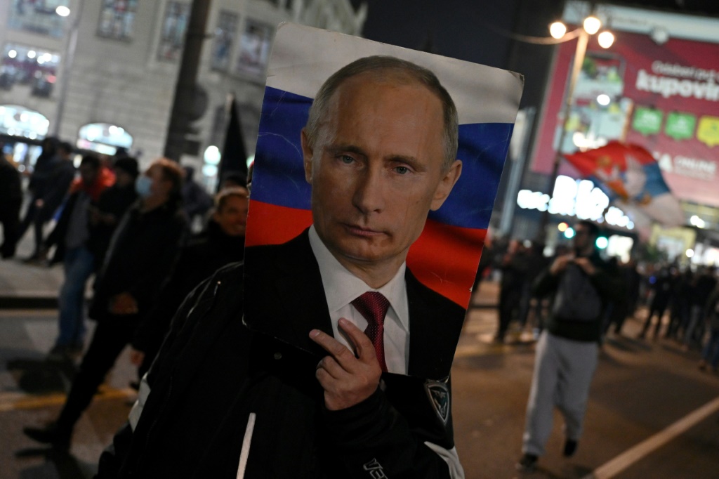    رجل يحمل صورة للرئيس الروسي فلاديمير بوتين خلال تظاهرة دعت إليها منظمات يمينية في صربيا في 4 آذار/مارس 2022 (أ ف ب)