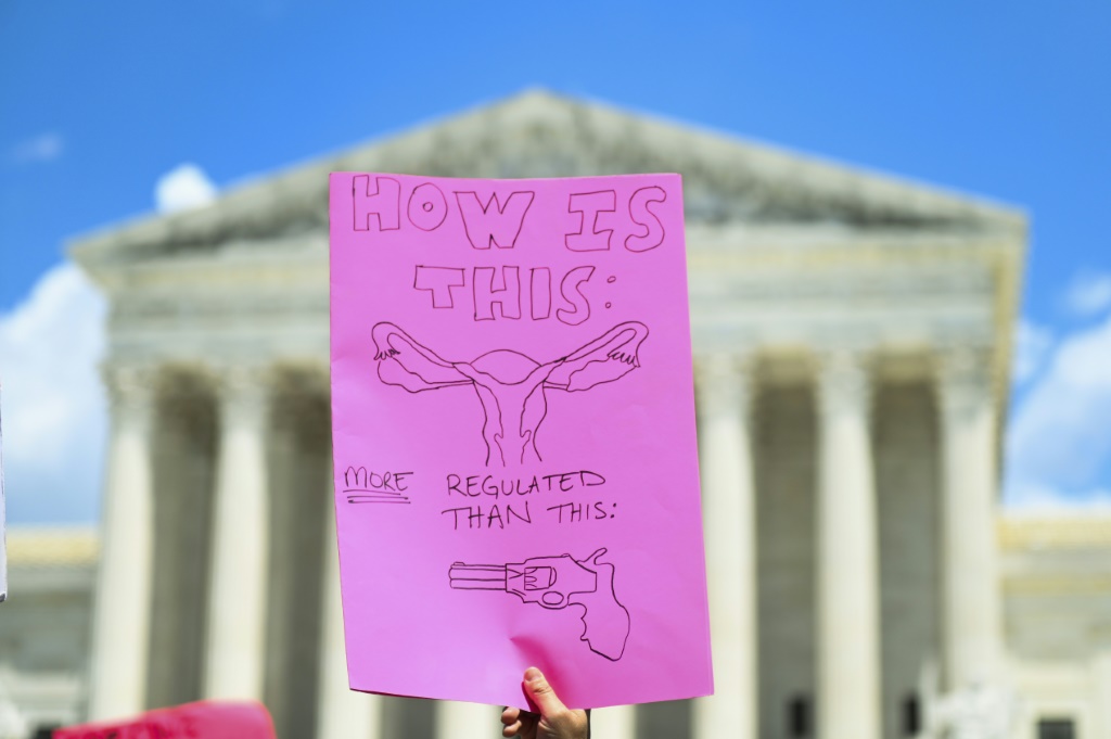 متظاهر من حقوق الإجهاض يحمل لافتة خلال مسيرة أمام المحكمة العليا الأمريكية في واشنطن العاصمة في 25 يونيو 2022 (ا ف ب)