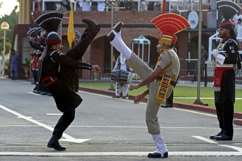 جنديان هندي (يمين) وباكستاني يؤديان مراسم حدودية في واغاه على بعد 35 كلم عن أمريستار، في الأول من آب/أغسطس 2022 (ا ف ب)