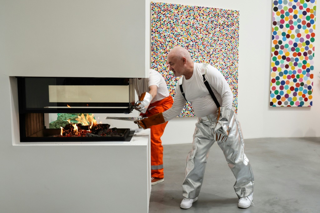 الفنان البريطاني داميان هيرست يحرق أحد أعماله في معرض "نيوبورت ستريت" في لندن بتاريخ 11 تشرين الاول/أكتوبر 2022 (ا ف ب)