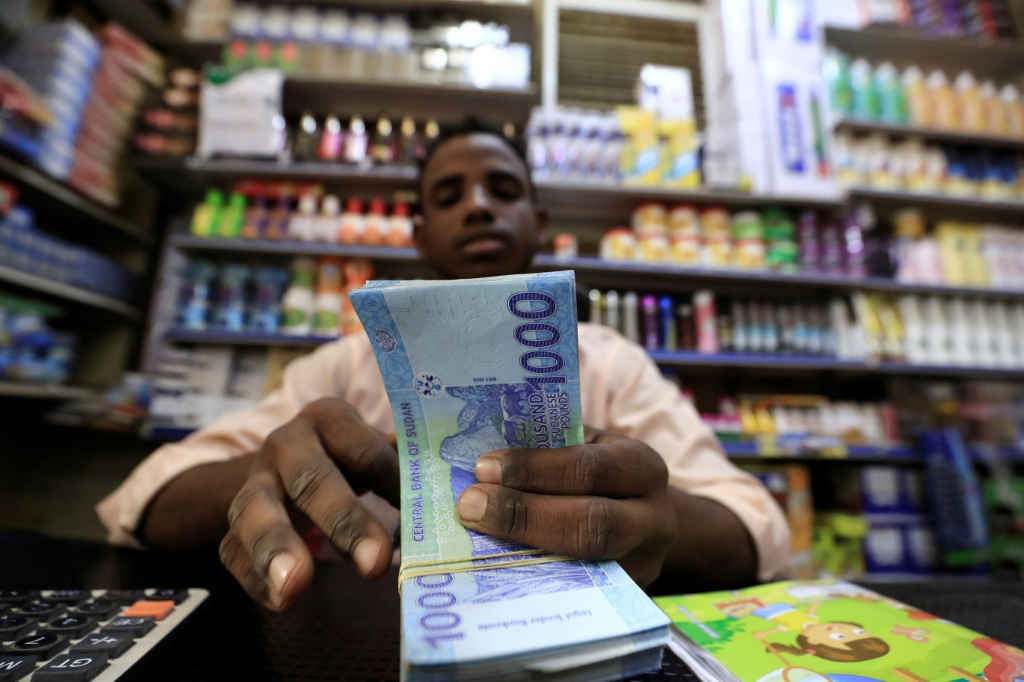  صاحب محل تجاري يعد كدسة من الأوراق المالية في العاصمة السودانية الخرطوم في 19 كانون الثاني/يناير 2023 (أ ف ب)