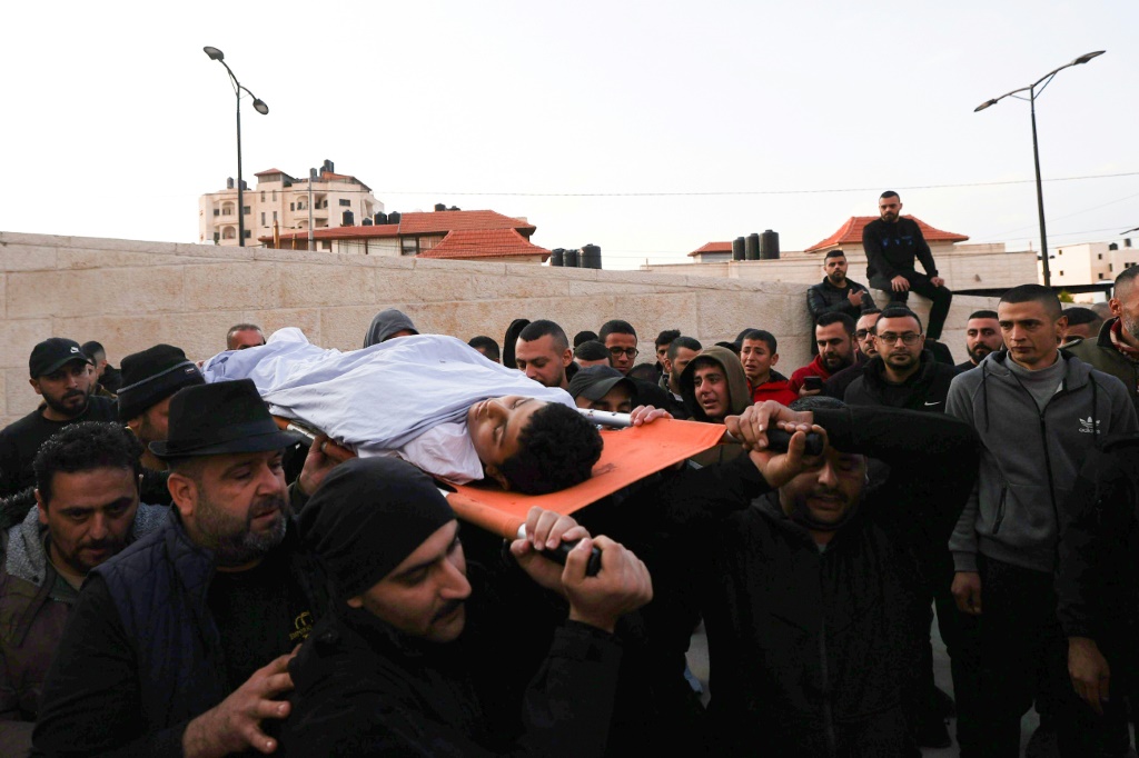 يحملون جثة الفتى الفلسطيني قصي واكد الذي قتل برصاص اسرائيلي خلال دهم مخيم جنين في الضفة الغربية المحتلة في 12 شباط/فبراير 2023 (ا ف ب)
