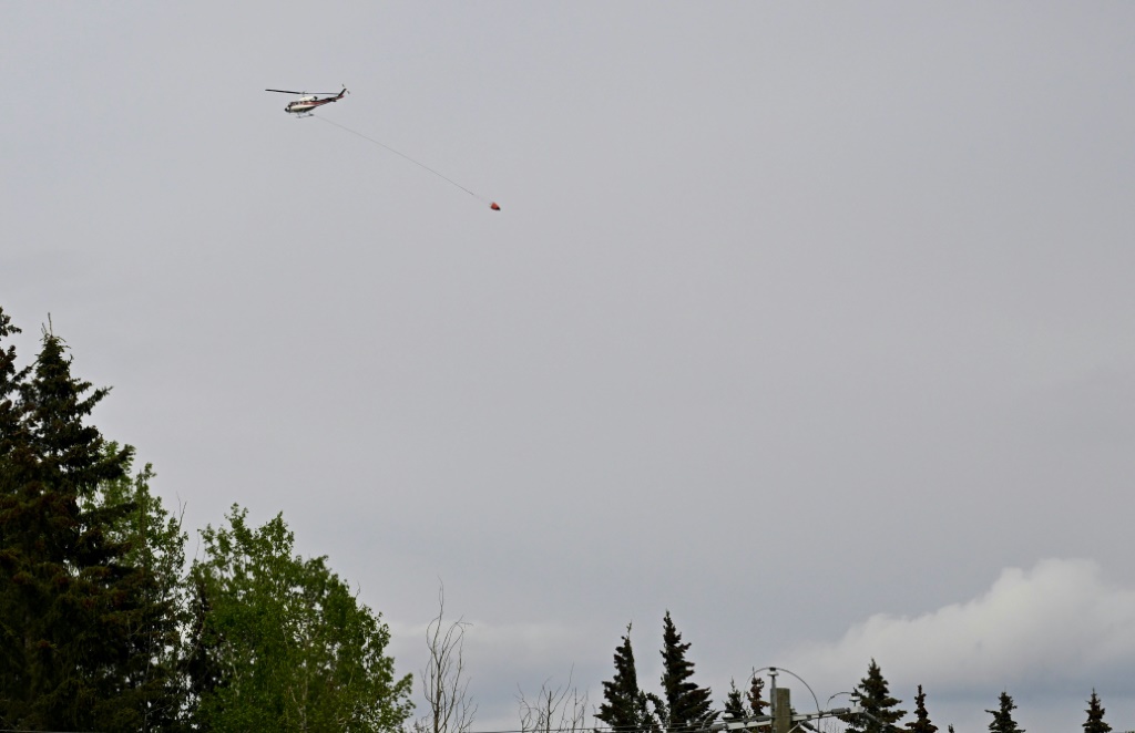 طائرة مروحية تشارك في عمليات مكافحة حرائق الغابات قرب بلدة درايتون فالي بمقاطعة ألبرتا الكندية في السابع من أيار/مايو 2023 (ا ف ب)