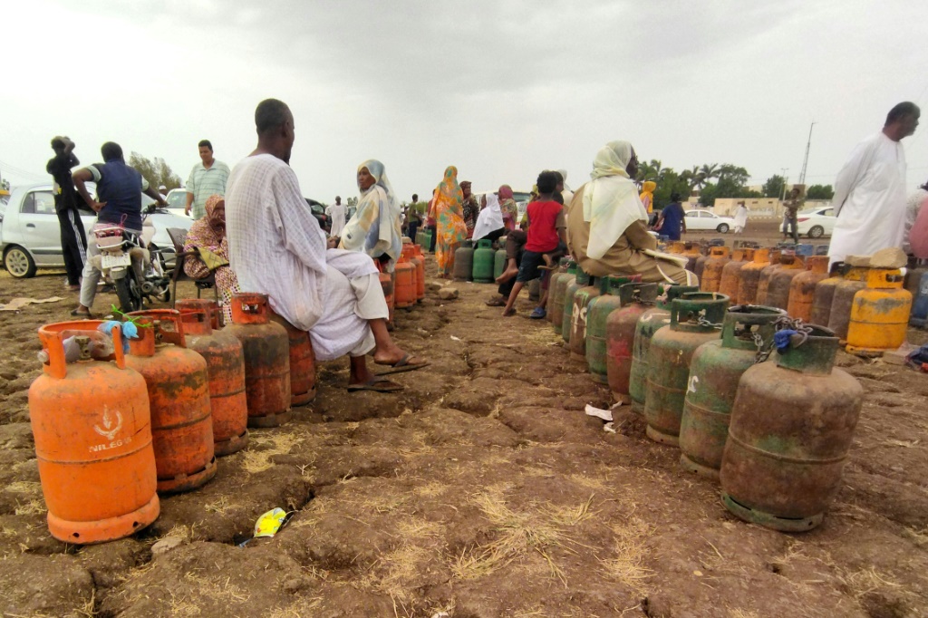     سودانيون ينتظرون وصول شاحنة غاز لاستبدال عبواتهم الفارغة في ود مدني في 14 حزيران/يونيو 2023 (أ ف ب)