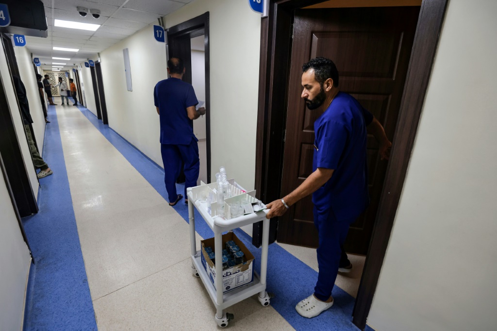 طاقم طبي خلال توزيعه ادوية على مرضى في مركز القنال للتأهيل الاجتماعي في بغداد في 11 تموز/يوليو 2023 (ا ف ب)