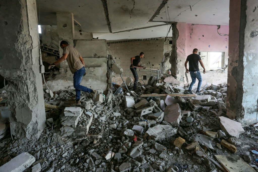 فلسطينيون يبحثون بين الأنقاض عن ضحايا بعد ضربة إسرائيلية على رفح في جنوب قطاع غزة في 22 تشرين الأول/أكتوبر 2023   (أ ف ب)