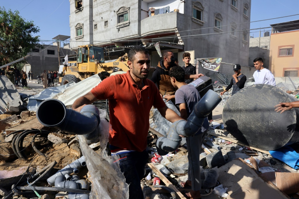 فلسطينيون وسط ركام بعد قصف إسرائيلي في مخيم رفح في جنوب قطاع غزة في 25 تشرين الأول/أكتوبر 2023 (ا ف ب)