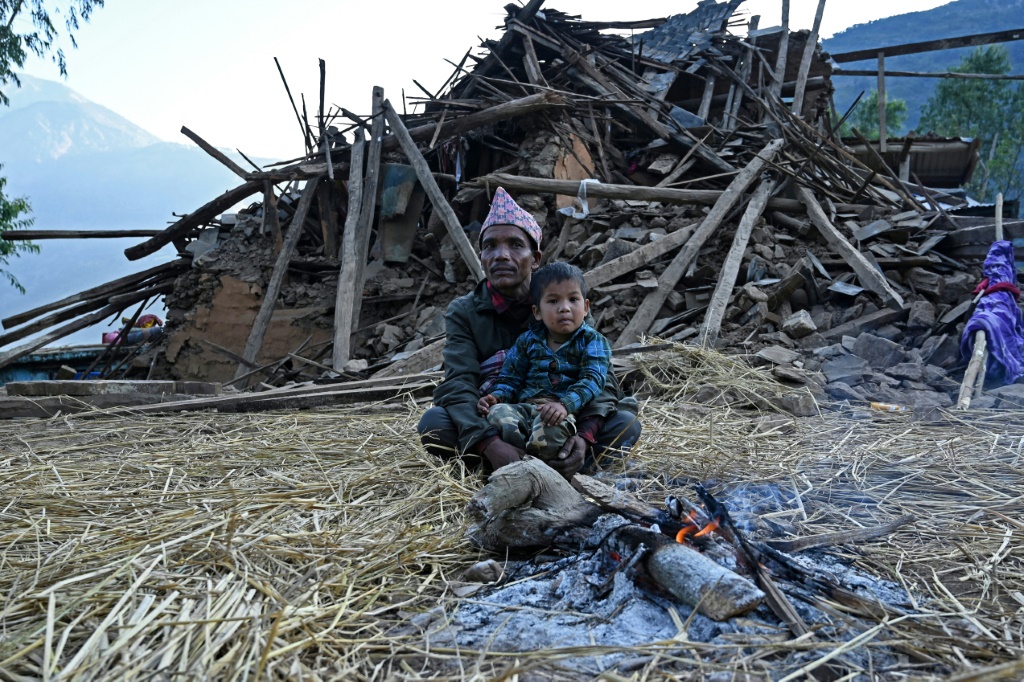 ناجون من الزلزال الأخير يجلسون أمام منزل مدمّر في قرية شيوري في منطقة جاجاركوت في الخامس من تشرين الثاني/نوفمبر 2023 (ا ف ب)