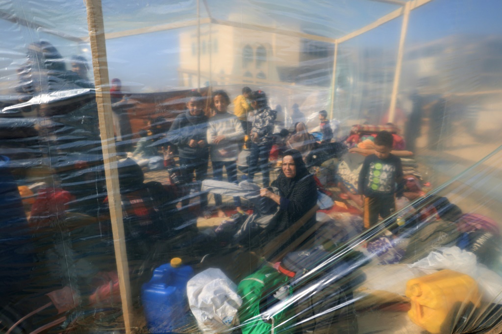 نازحون فلسطينيون تحت خيمة بلاستيكية في رفح في السادس من كانون الأول/ديسمبر 2023 (أ ف ب)  &nbsp;