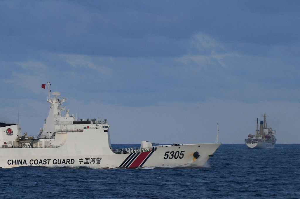 سفينة تابعة لخفر السواحل الصيني بالقرب من سفينة فيليبينية (على اليمين) في بحر الصين الجنوبي المتنازع عليه في 10 كانون الأول/ديسمبر 2023 (ا ف ب)   