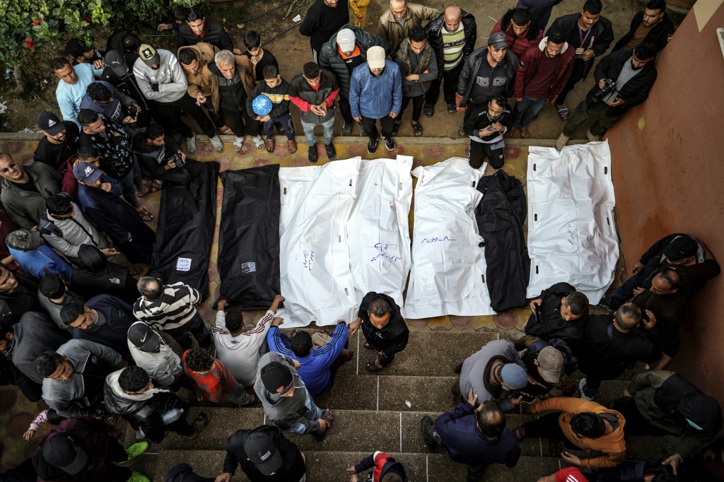 فلسطينيون يحيطون بجثث قتلى قصفوا إسرائيل، في باحة مستشفى ناصر في مدينة يو خانس في 27 كانون الأول/ديسمبر 2023 (ا ف ب)