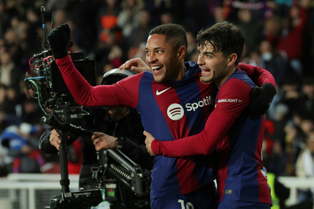 البرازيلي فيتور روكي لاعب برشلونة (إلى اليسار) يحتفل بهدفه في مرمى أوساسونا، رفقة بيدري، في مباراة مؤجلة من المرحلة العشرين ضمن الدوري الإسباني لكرة القدم. 31 كانون الثاني/يناير 2024 (ا ف ب)