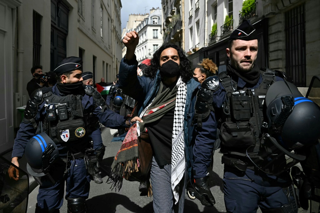 عناصر من الشرطة الفرنسية يقتادون أحد المعتصمين تضامنا مع الفلسطينيين في معهد العلوم السياسية في باريس في الثالث من أيار/مايو 2024 (ا ف ب)