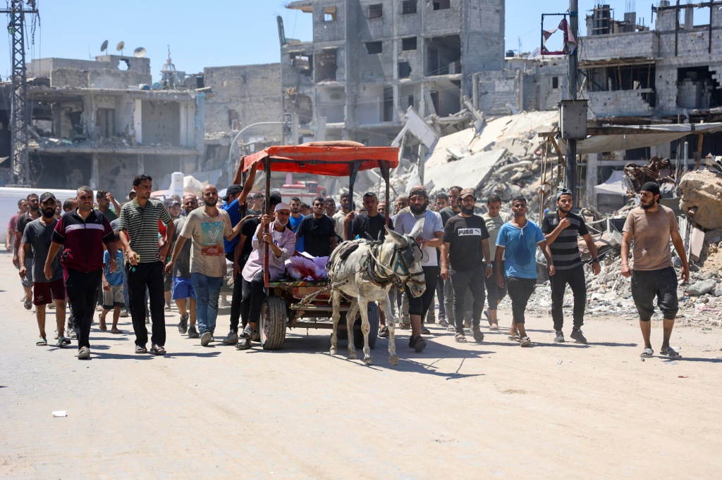  فلسطينيون ينقلون جثث أقاربهم الذين قتلوا في قصف إسرائيلي بالقرب من مدينة غزة في 22 حزيران/يونيو 2024 (ا ف ب)