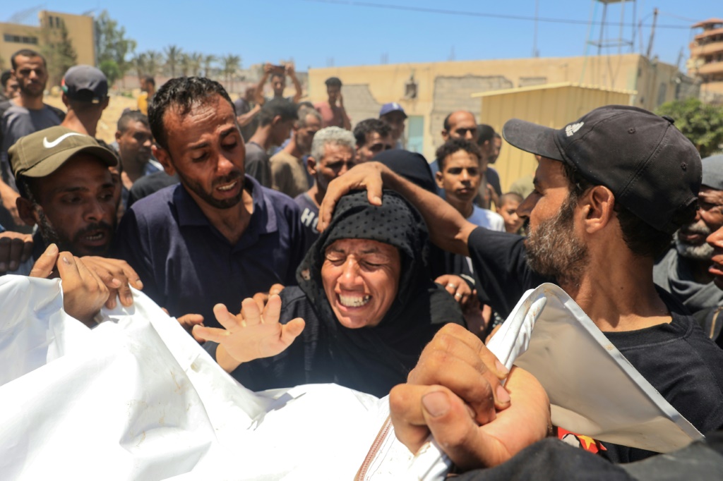 فلسطينية تنتحب أمام جثة أحد أفراد أسرتها في مشرحة مستشفى ناصر في خان يونس بعد القصف على مخيم المواصي في 13 تموز/يوليو 2024 (أ ف ب)   