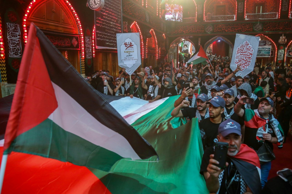كانت الأعلام الفلسطينية بارزة في مراسم الأربعين في كربلاء هذا العام (أ ف ب)   