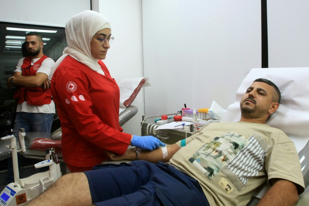  رجل يتبرع بالدم في مدينة صيدا بجنوب لبنان في 17 سبتمبر 2024، بعد يوم من الانفجارات المميتة (أ ف ب)   