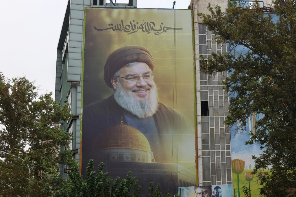 لوحة تحمل رسما للأمين العام لحزب الله حسن نصرالله الذي قتل في غارة إسرائيلية في ضاحية بيروت الجنوبية، مرفوعة في طهران في 30 أيلول/سبتمبر 2024 (أ ف ب)   
