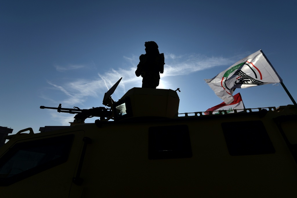 جانب من عرض عسكري أقامته قوات الحشد الشعبي والشرطة العراقية على طريق سريع خلال احتفالية إحياء لذكرى هزيمة تنظيم الدولة الإسلامية في مدينة الموصل شمال العراق في 10 كانون الأول/ديسمبر 2024 (أ ف ب)